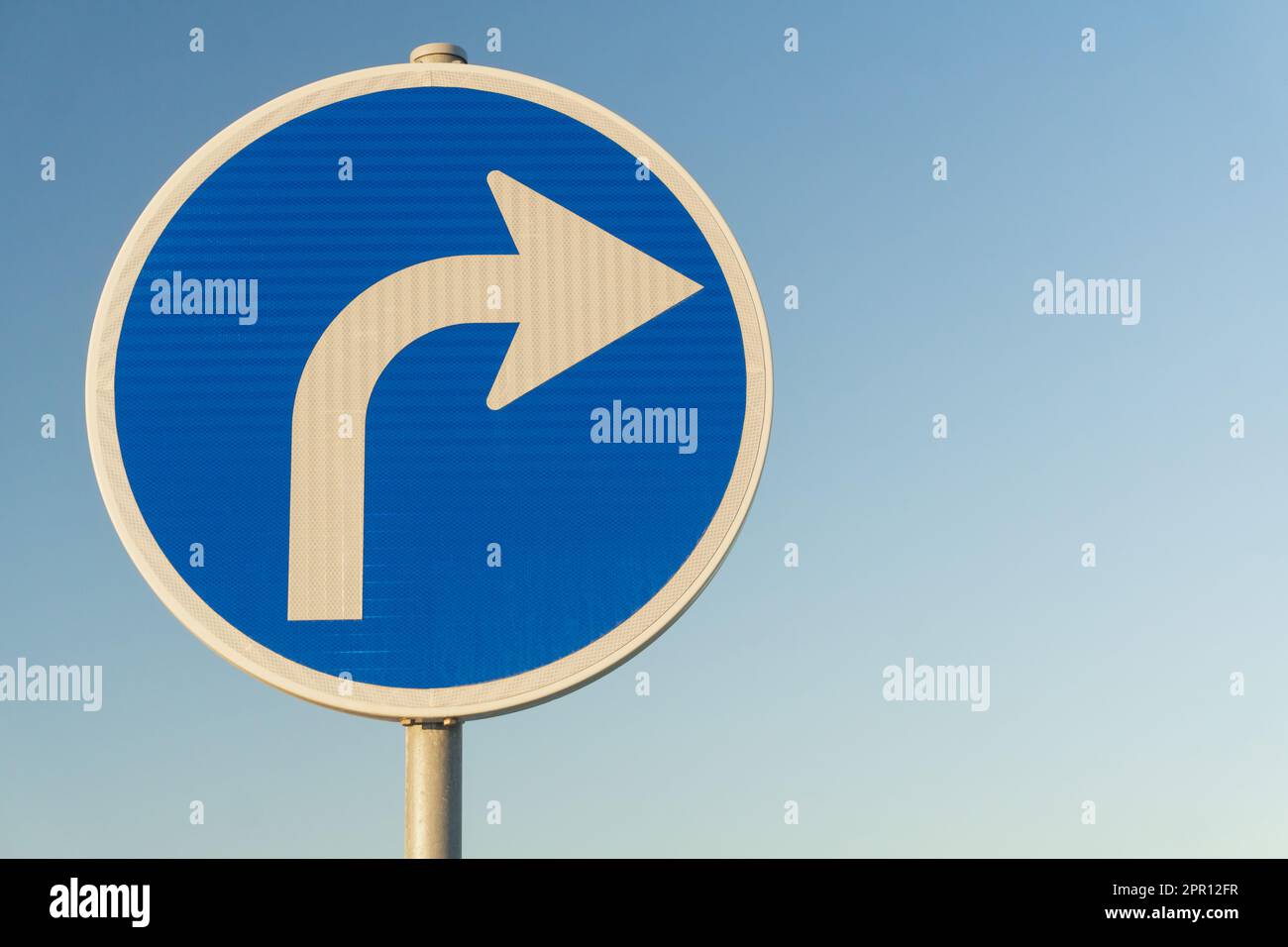 Straßenschild blau rechts Blinker auf Himmel Hintergrund Nahaufnahme Stockfoto