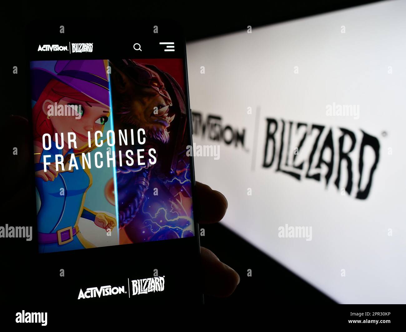 Person, die ein Mobiltelefon mit einer Webseite des US-amerikanischen Videospielunternehmens Activision Blizzard Inc. Auf dem Bildschirm mit Logo hält. Konzentrieren Sie sich auf die Mitte des Telefondisplays. Stockfoto