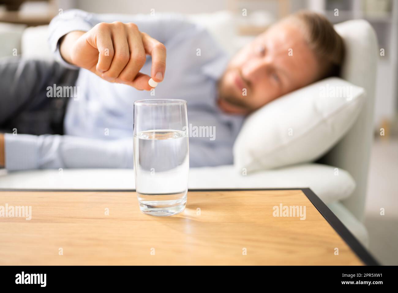 Mann Mit Kater, Der Medizin-Pille Nimmt Stockfoto