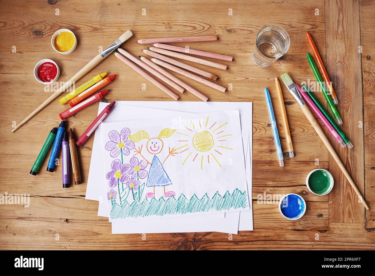 Sehen Sie, was die anderen nicht sehen. Aufnahme einer Zeichnung mit Malutensilien und Bleistiften auf einem Holztisch. Stockfoto