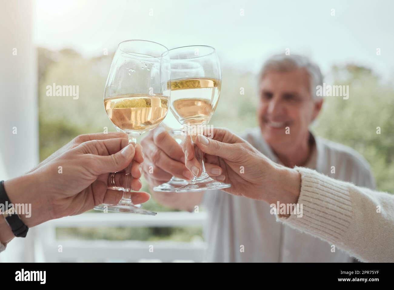 Als ich aufwuchs, lernte ich beim Abendessen wichtige Lektionen aus dem Leben. Aufnahme eines älteren Mannes, der zu Hause mit nicht erkennbaren Familienmitgliedern röste. Stockfoto