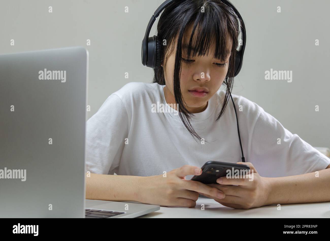 Mädchen mit Kopfhörern studieren online mit Computer-Laptop und hören entspannende Musik oder spielen Internet Social Media zu Hause. Stockfoto