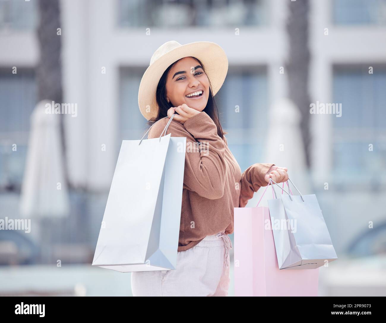 Ein weiterer erfolgreicher Einkaufstag. Eine glückliche junge Frau, die einen Tag mit Einkaufen verbringt. Stockfoto