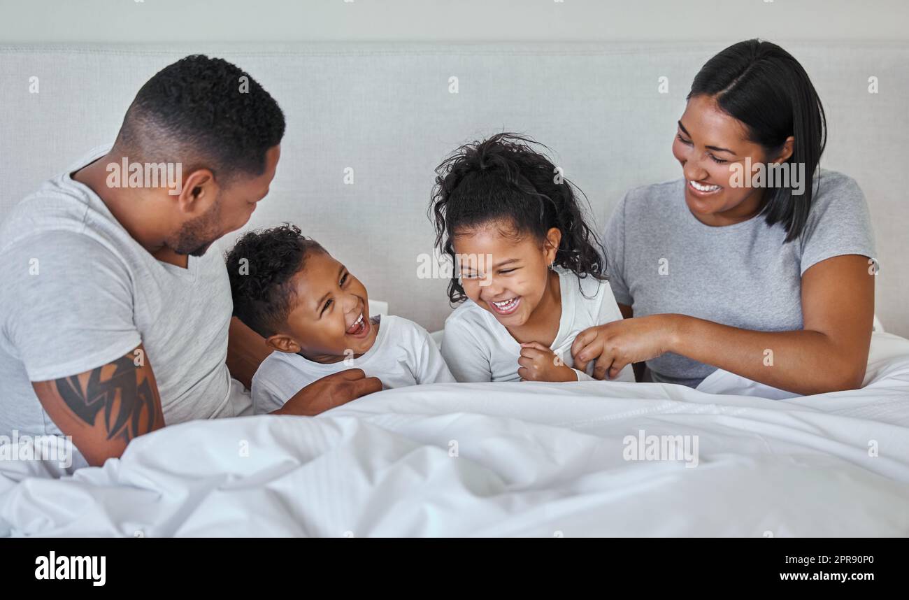 .. Eine schöne junge Familie, die im Bett miteinander redet und sich verbindet. Stockfoto