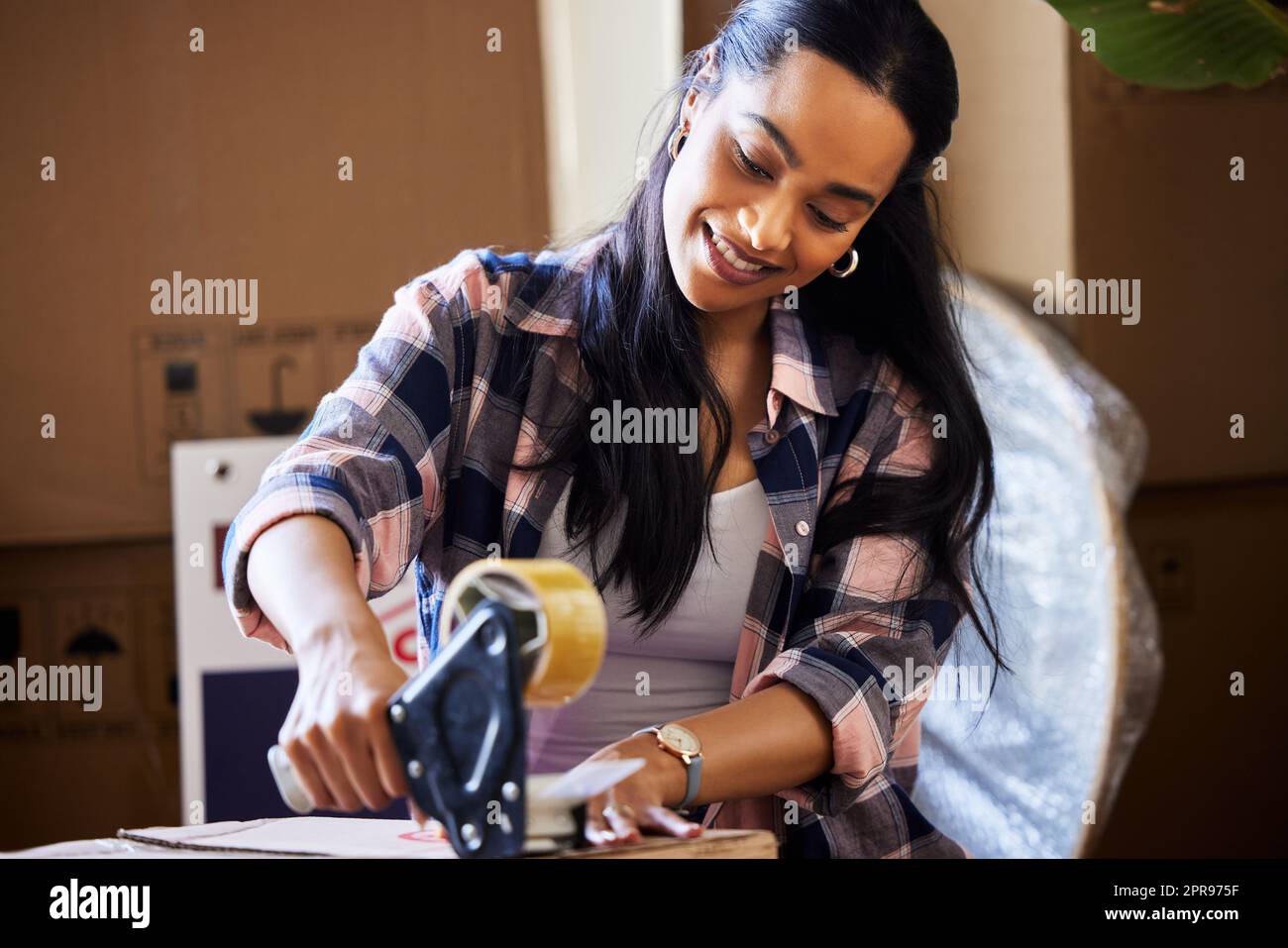 Wo auch immer Sie hingehen, Sie können Glück finden. Eine junge Frau, die sich einpacke, um sich zu bewegen. Stockfoto