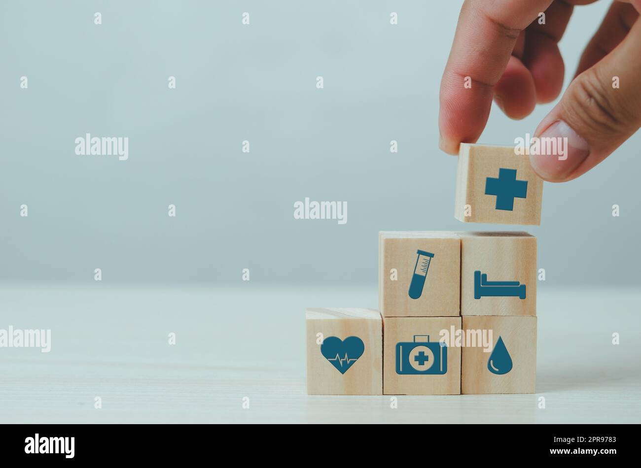 Hand setzen Holzwürfel mit Versicherung medizinische Symbol auf Tisch kopieren Raum.Geschäftskonzepte. Stockfoto