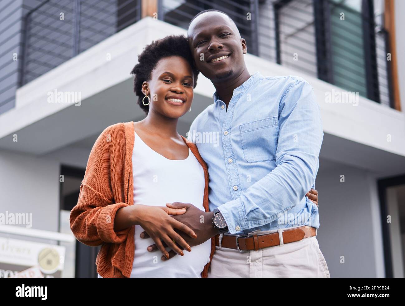 Elternschaft an unserem neuen Ort beginnen. Porträt eines jungen Paares, das vor ihrem neuen Zuhause steht. Stockfoto
