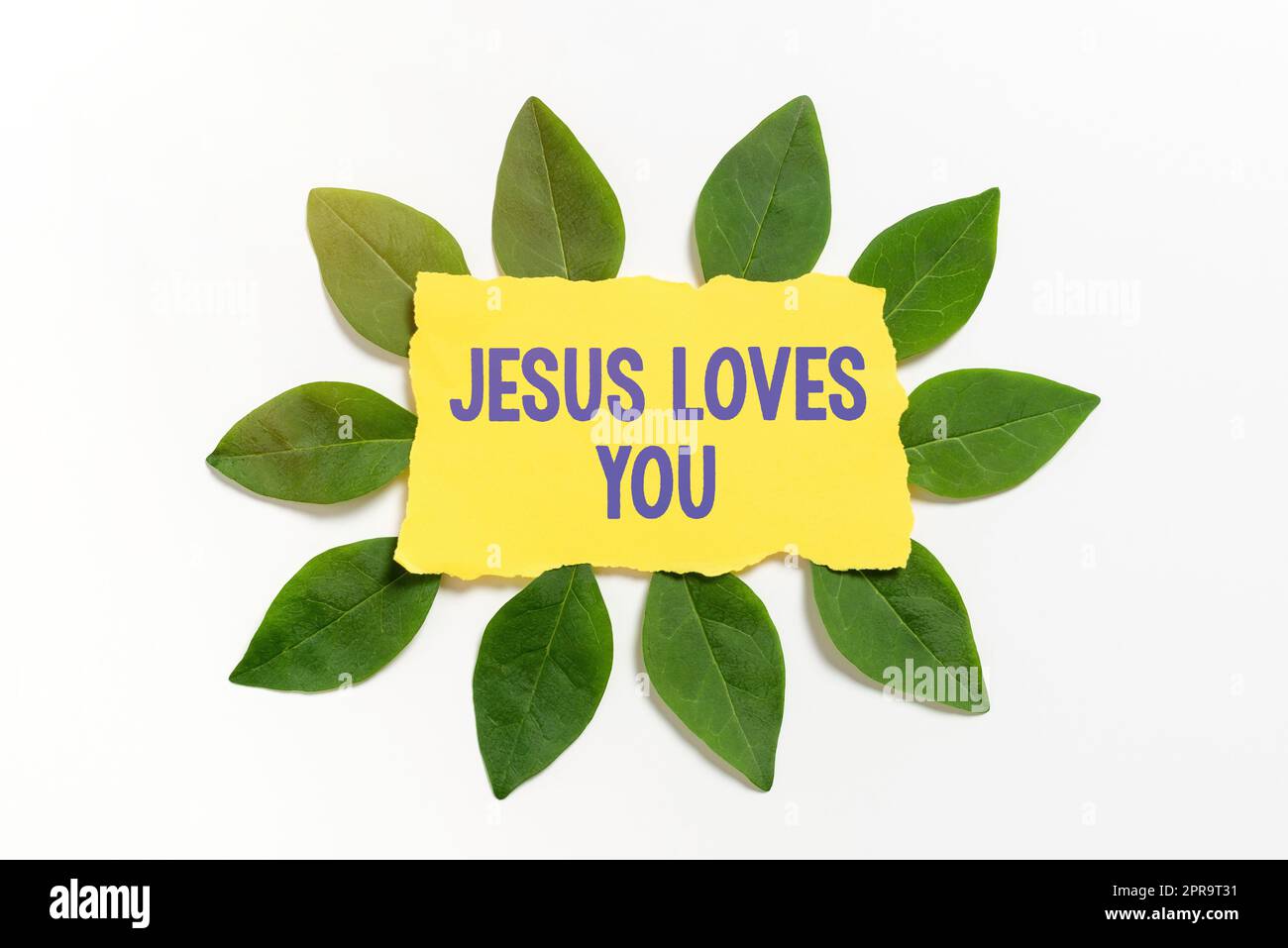 Die Inspiration zeigt das Zeichen Jesus liebt dich. Die Geschäftsübersicht glaubt an den Herrn, dass der Glaube religiöse Person Blankfarbpapier mit Blättern für die Einladungskarte umgeben ist. Stockfoto