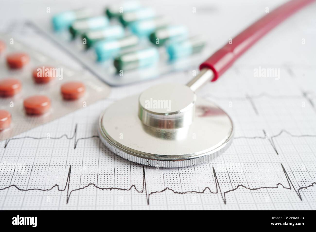 Stethoskop im Elektrokardiogramm (EKG) mit Medikament, Herzwelle, Herzinfarkt, Kardiogrammbericht. Stockfoto