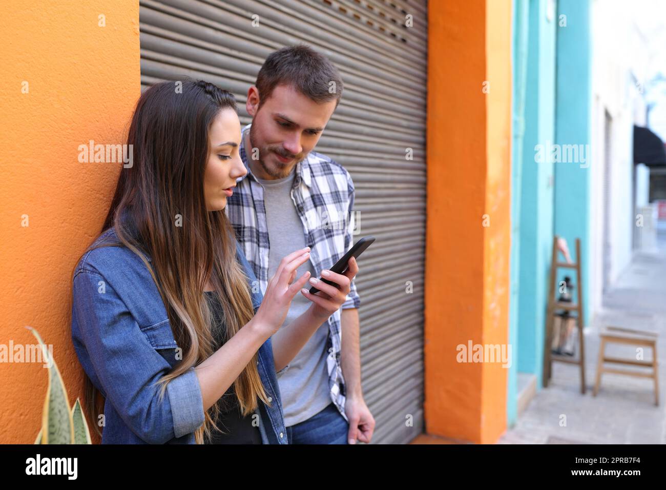 Freunde, die über Smartphone-Inhalte sprechen Stockfoto