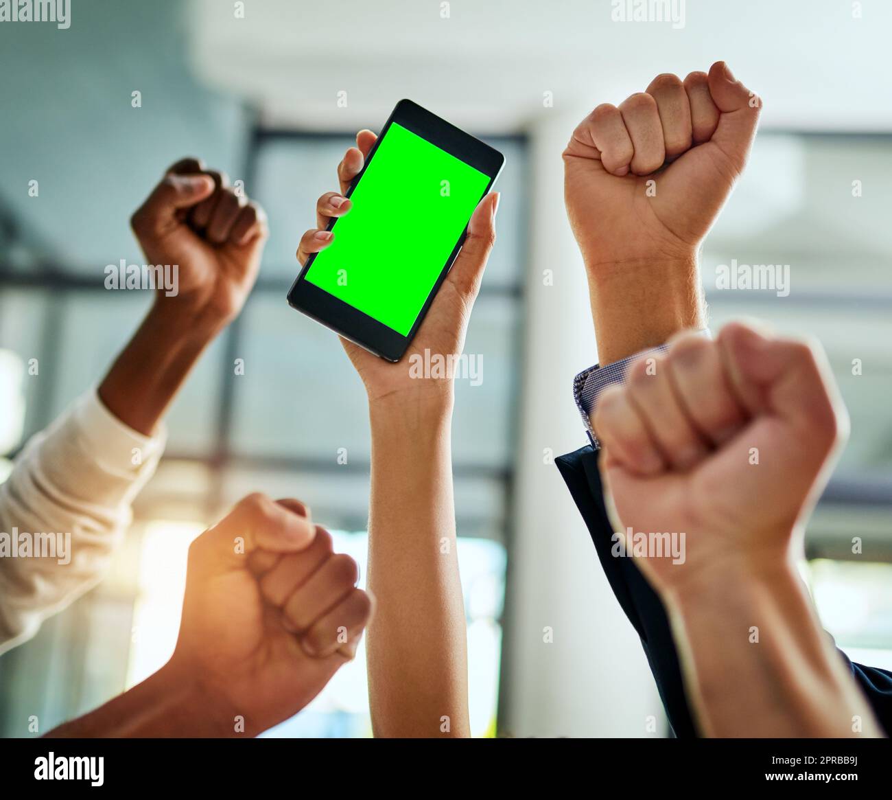 Hände von Geschäftsleuten, die auf einem Telefon mit Chroma Key und grünem Bildschirm für Kopierbereich jubeln und gute Nachrichten feiern. Aufgeregtes Team von Büromitarbeitern, die ihre Handbewegung für Erfolg, Sieg und Sieg zeigen Stockfoto