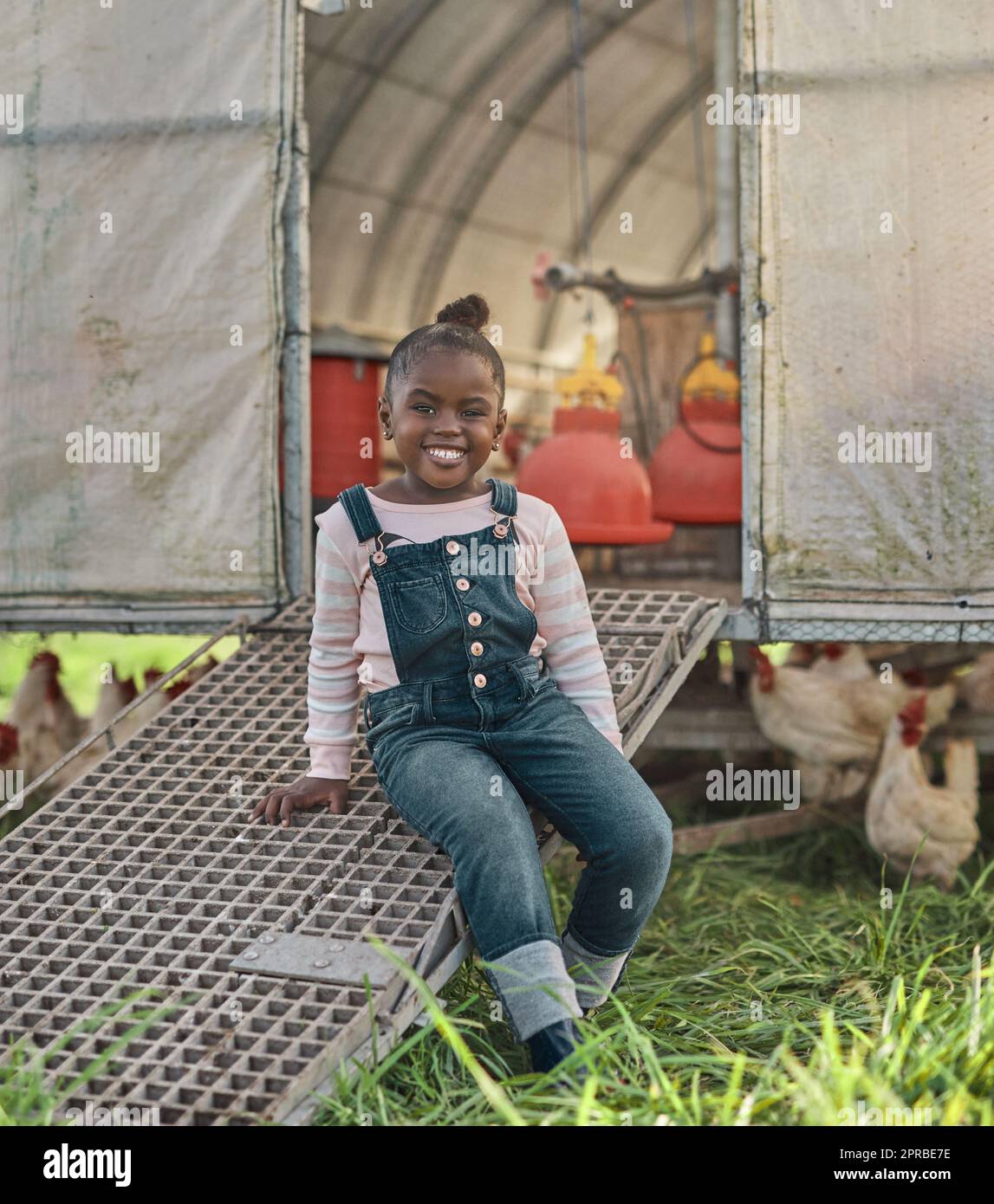 Wo Tiere sind, gibt es ein glückliches Kind. Portrait eines niedlichen kleinen Mädchens, das Spaß auf einer Hühnerfarm hat. Stockfoto