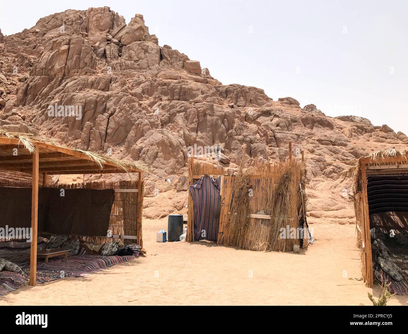 Eine fadenscheinige, verfallene, zerbrechliche, arme Wohnung, ein Beduinengebäude aus Stroh, Zweige in einer sandigen heißen Wüste im Sand des Parkis Stockfoto