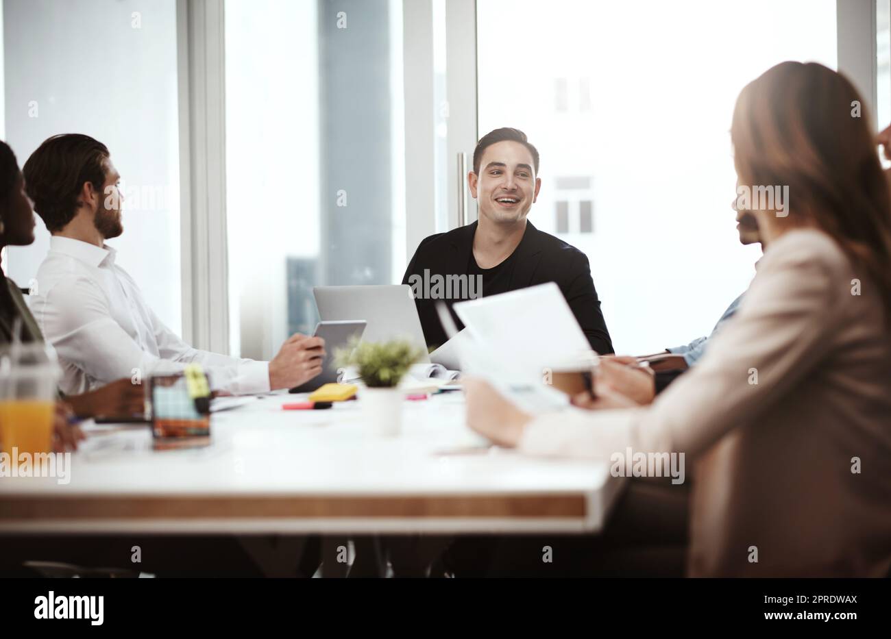 Das Team fühlt sich jetzt wirklich motiviert: Ein Geschäftsmann, der sich mit seinen Kollegen in einem Sitzungssaal trifft. Stockfoto