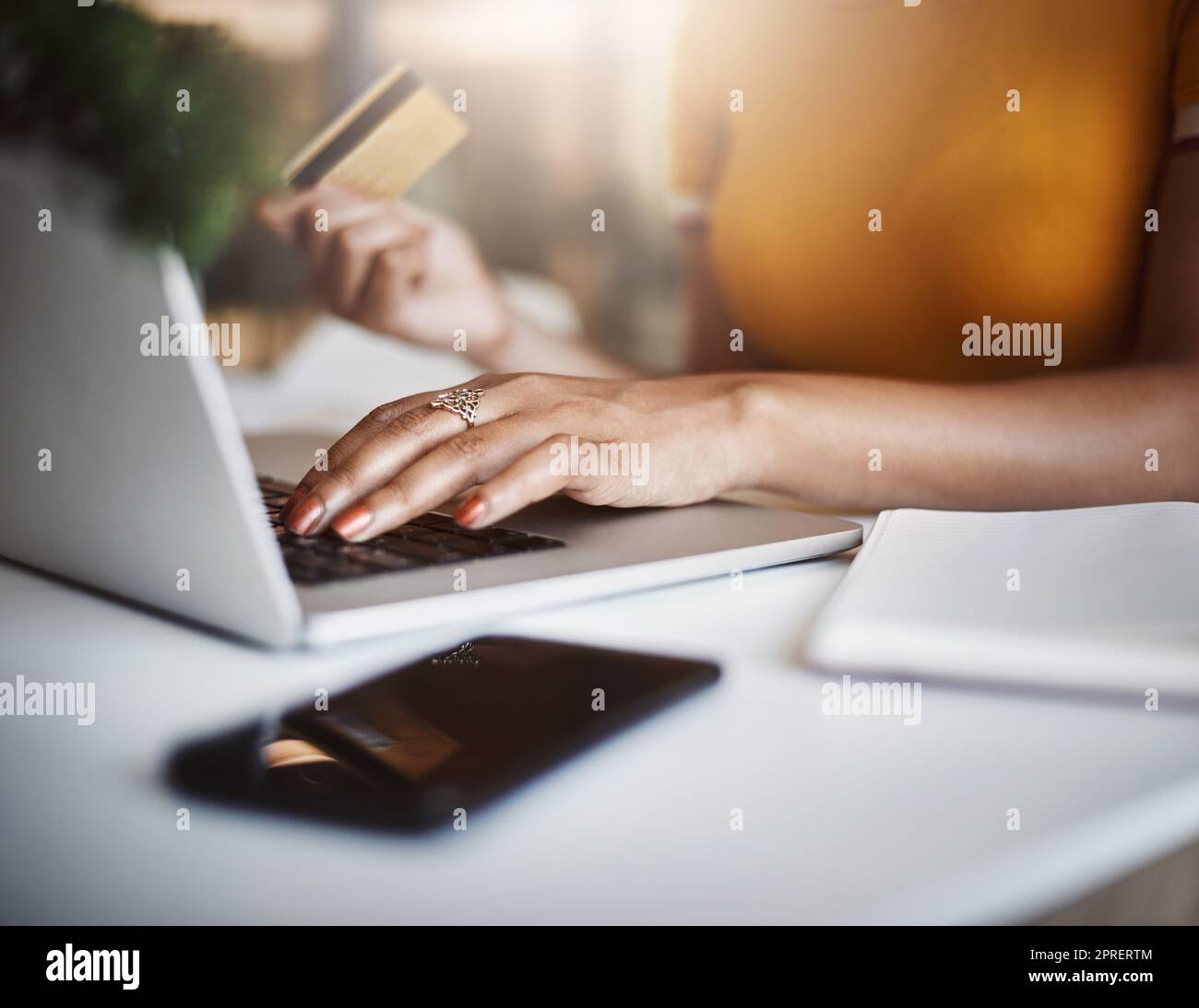 Zahlungen an ihr Unternehmen zu leisten, war noch nie so einfach. High-Angle-Aufnahme einer unverkennbaren Designerin, die online in ihrem Heimbüro einkauft. Stockfoto