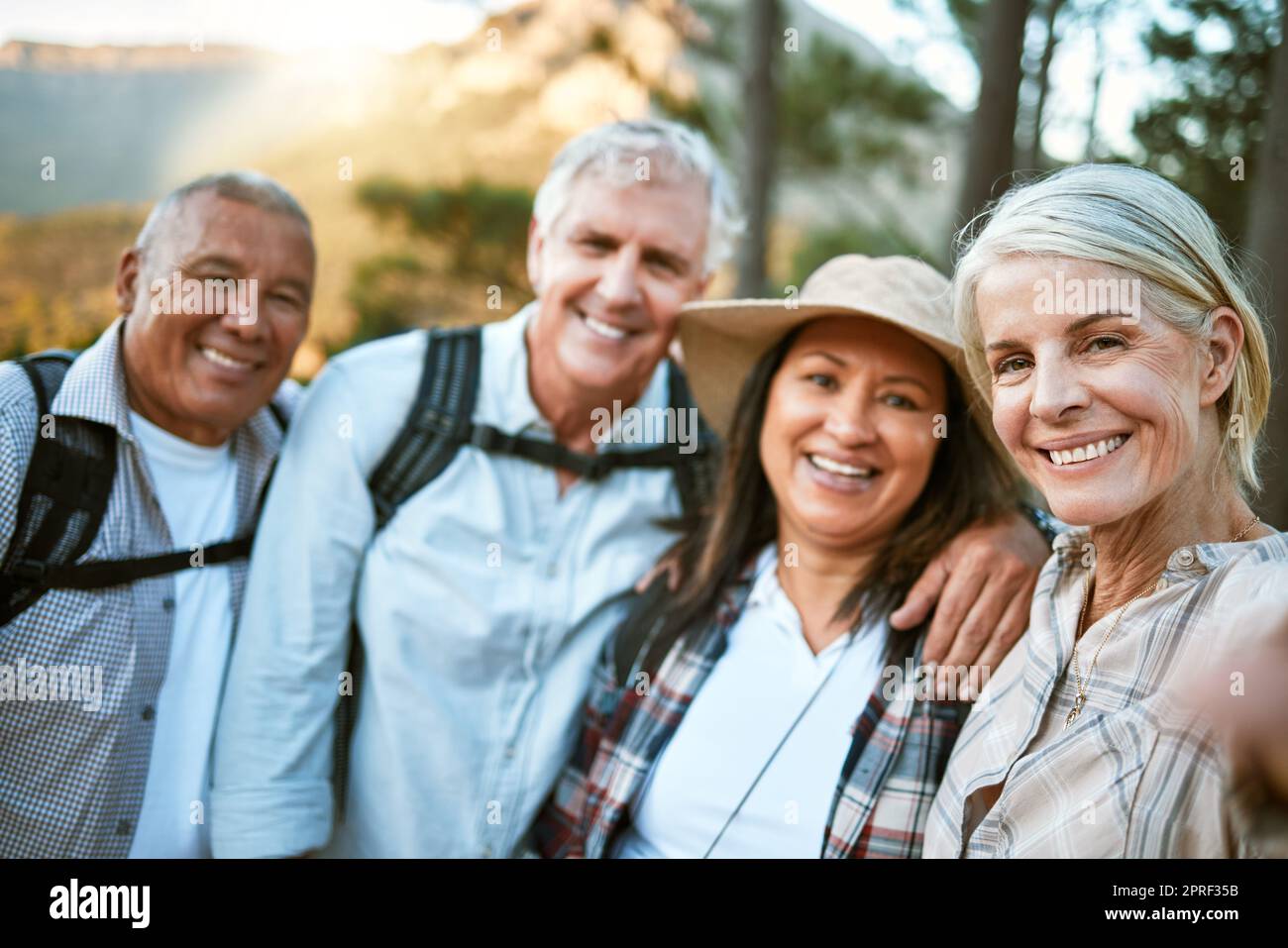 Ein Wanderteam macht ein Selfie in den natürlichen Wäldern, Bergen und Wäldern zusammen in der Natur. Gesunde, glückliche und ältere Paare draußen im Urlaub, um aktiv, Freundschaft und fit auf einer Wanderung zu bleiben Stockfoto