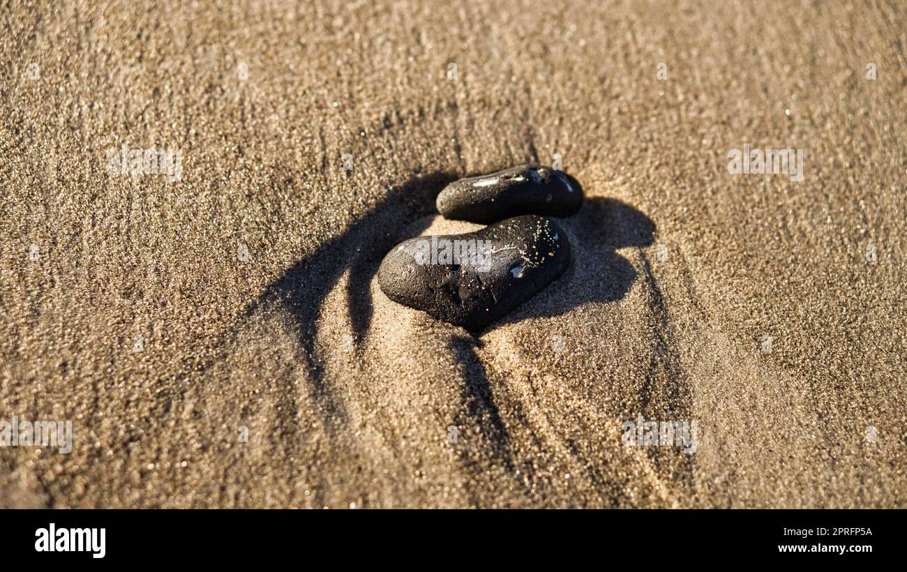 Herzförmiger Stein im Sand des Strandes an der Ostsee Stockfoto