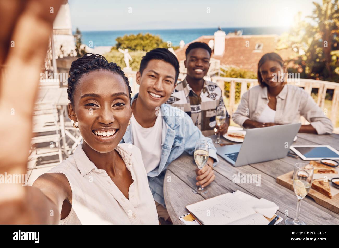 Selfie von Geschäftsleuten im Restaurant, die mit einem Laptop und Champagnergläsern oder Wein ein gemeinsames Marketinggespräch führen, um Projektziele zu feiern. Fröhliche Freunde oder Mitarbeiter bei Mitarbeiterfeiern Stockfoto