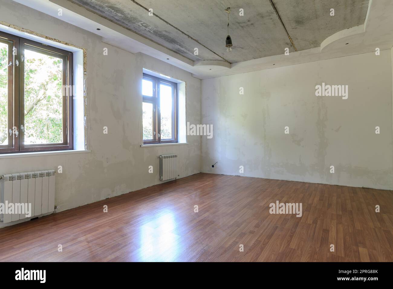 Interieur eines leeren Raumes während der Renovierung im Zimmer zwei große Fenster Stockfoto