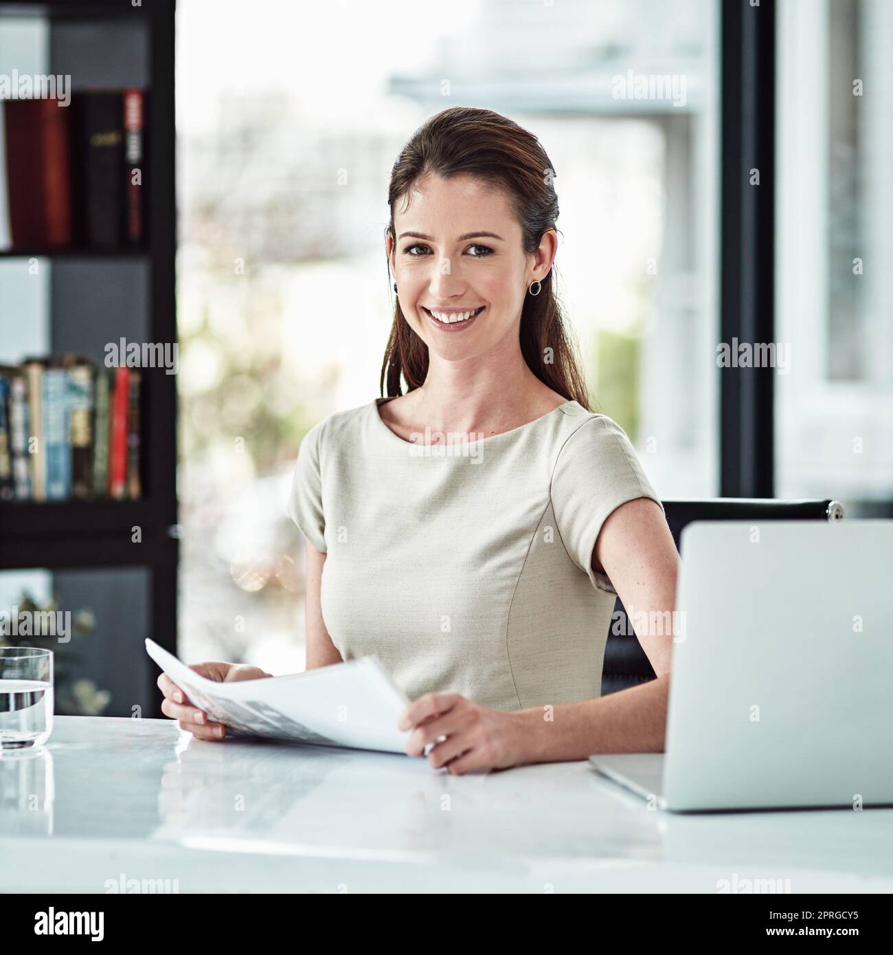 Erfüllt in ihrer Karriere und das zeigt sich. Porträt einer jungen Geschäftsfrau, die an ihrem Schreibtisch in einem Büro arbeitet. Stockfoto