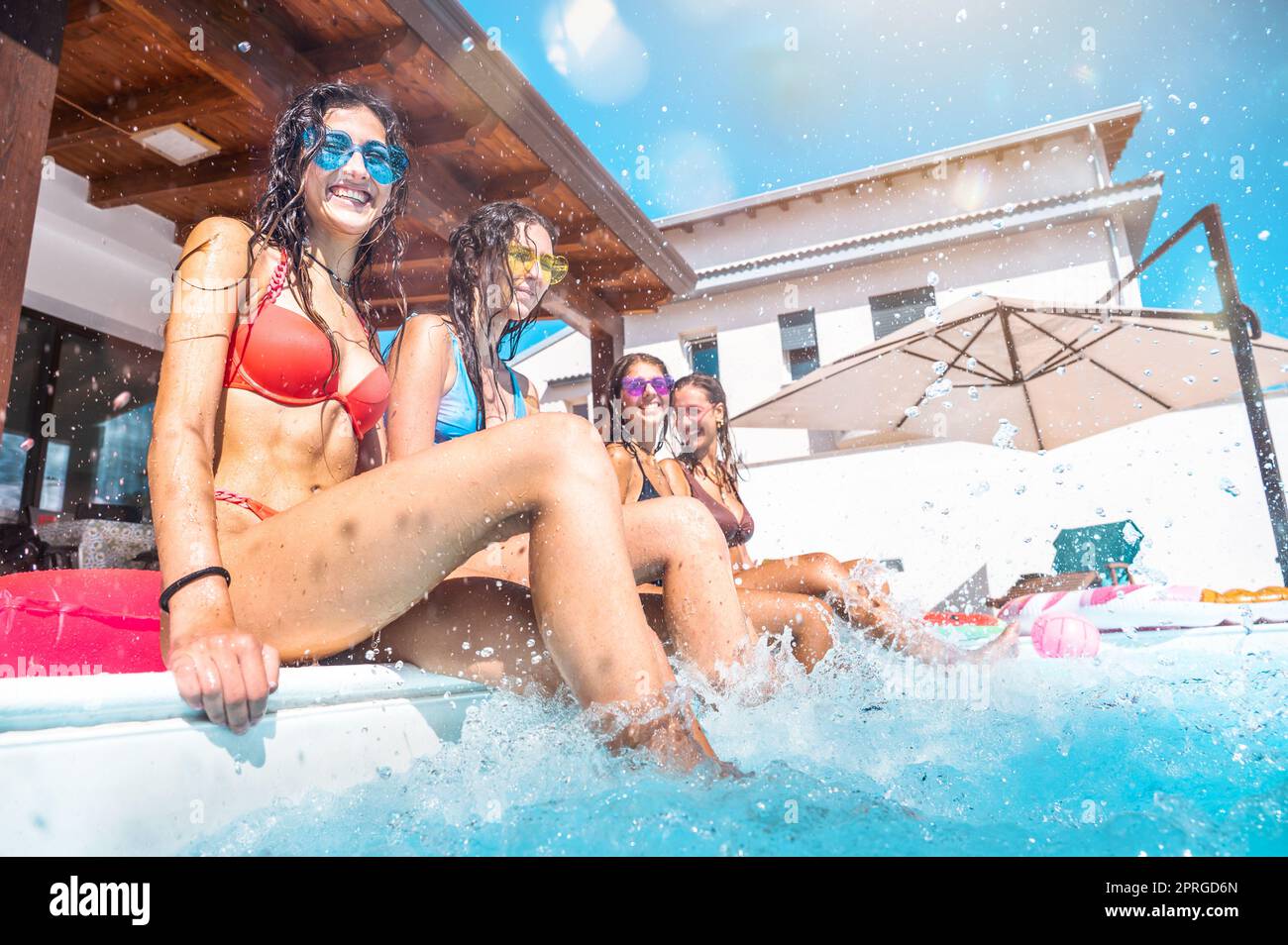 Eine Gruppe von Freunden im Badeanzug genießen Sie in einem Schwimmbad Stockfoto