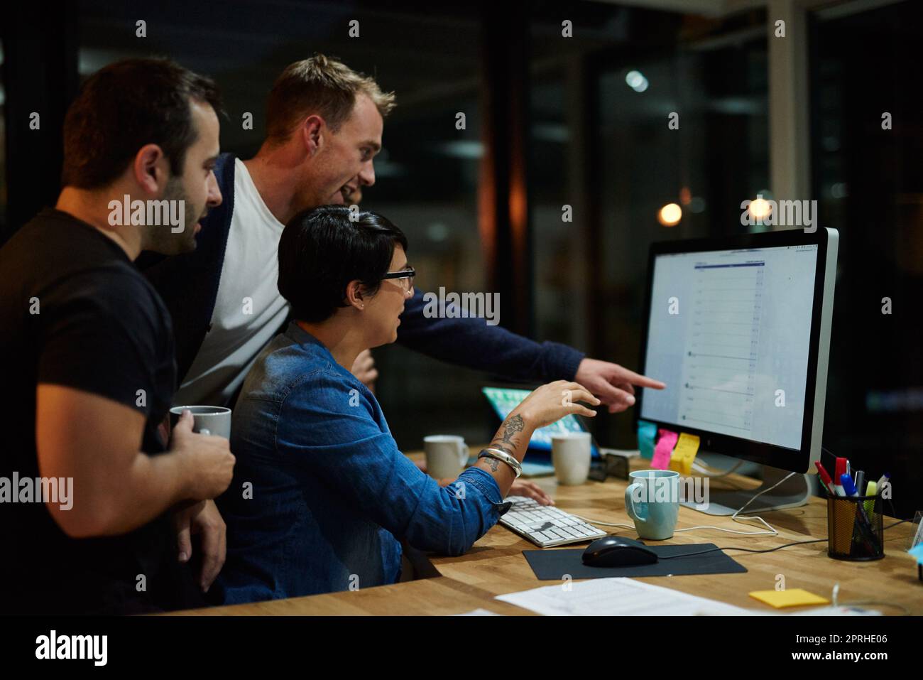 Gemeinsam an dem Projekt arbeiten. Mitarbeiter, die nachts in einem Büro arbeiten. Stockfoto