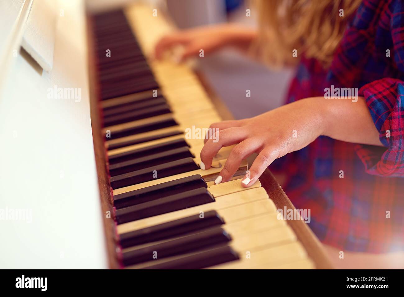 Ihre musikalischen Fähigkeiten zu schärfen. Nahaufnahme eines jungen Mädchens, das Klavier spielt. Stockfoto