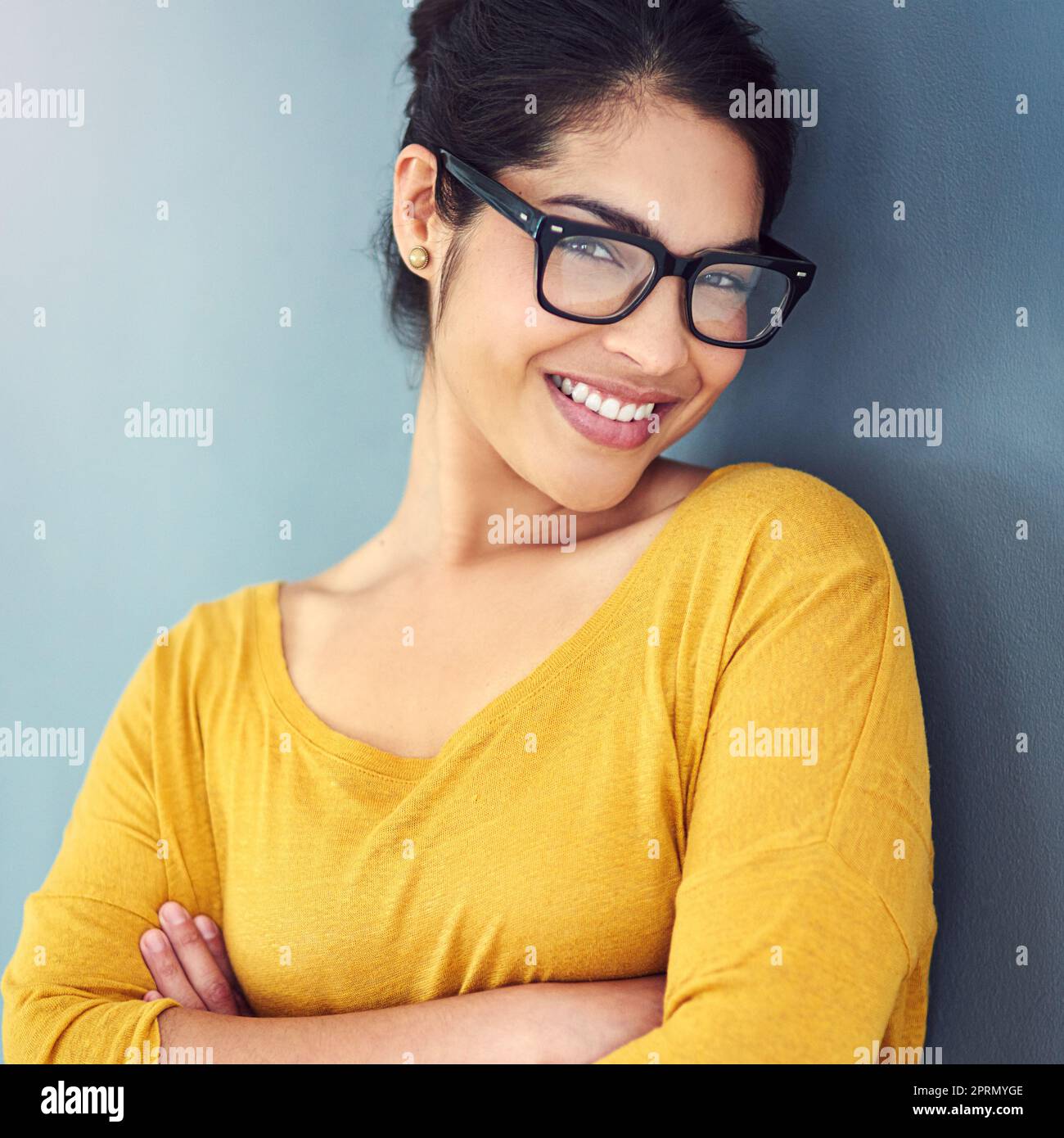 Selbstvertrauen. Studioportrait einer attraktiven jungen Frau, die vor blauem Hintergrund steht. Stockfoto