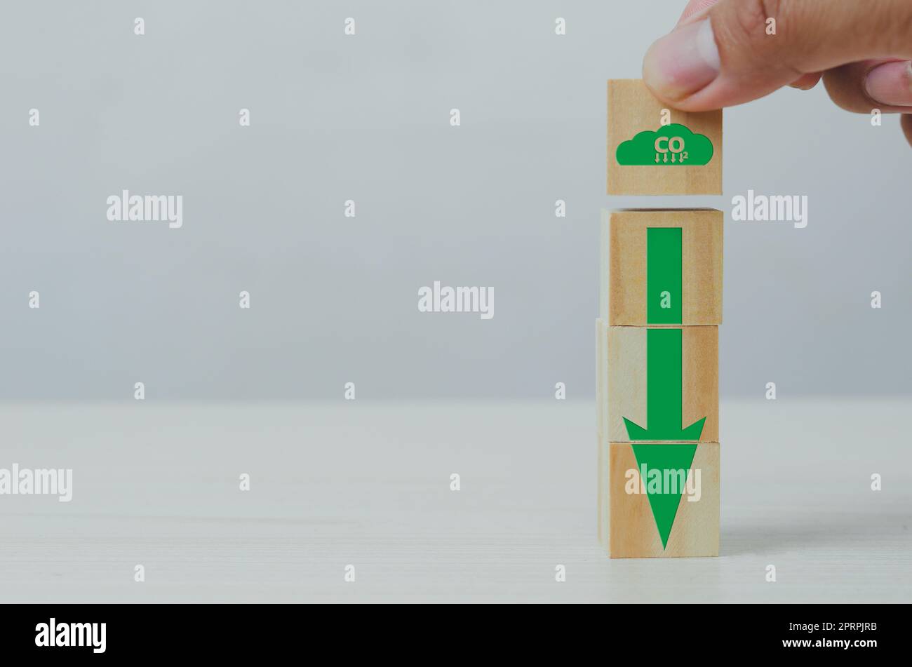 Netto Null und Kohlenstoff Kredit mit Hand halten Holz Würfel Block Symbol CO2 eco und Pfeil auf dem Hintergrund. Stockfoto