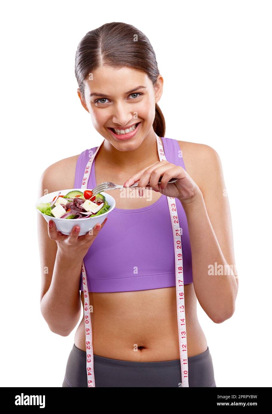 Fitness ist eine Belohnung, keine Strafe. Studio-Porträt einer schönen jungen Frau in Sportkleidung mit einer Schüssel Salat. Stockfoto