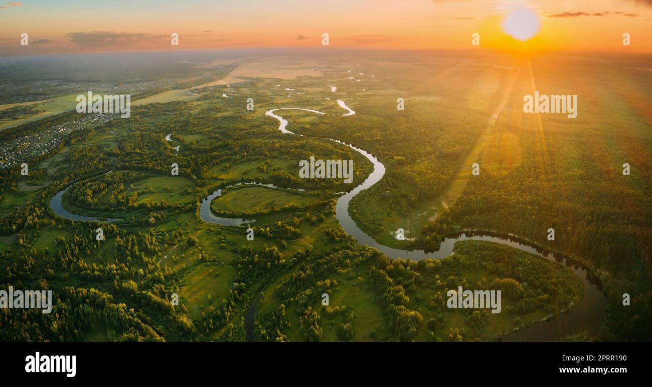 Luftaufnahme. Wunderschöner Sonnenuntergang Sonnenschein Über Green Forest, Meadow Und River Landscape Am Sonnigen Abend. Blick Von Oben Auf Die Europäische Natur Von High Attitude Bei Sonnenaufgang Im Sommer. Vogelperspektive. Panorama Stockfoto