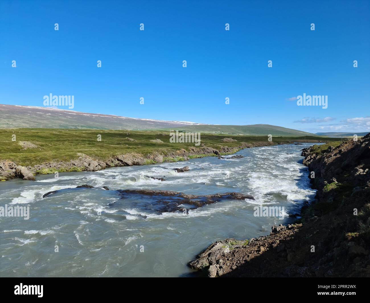Fantastische Landschaft mit fließenden Flüssen und Bächen mit Felsen und Gras in Island. Stockfoto