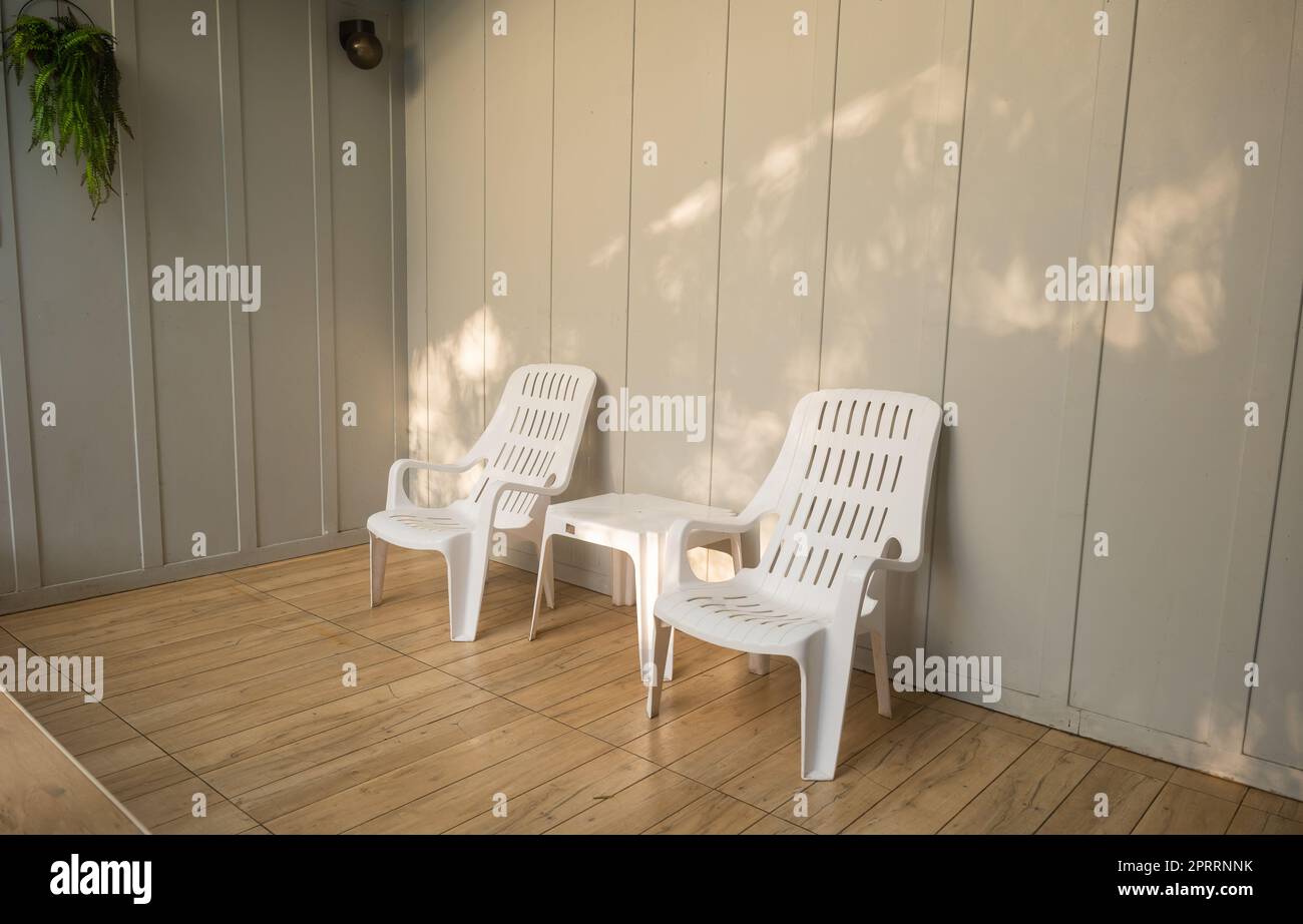 Niemand hat einen weißen Stuhl um den Außenpool im Resorthotel herum, der leer ist Stockfoto