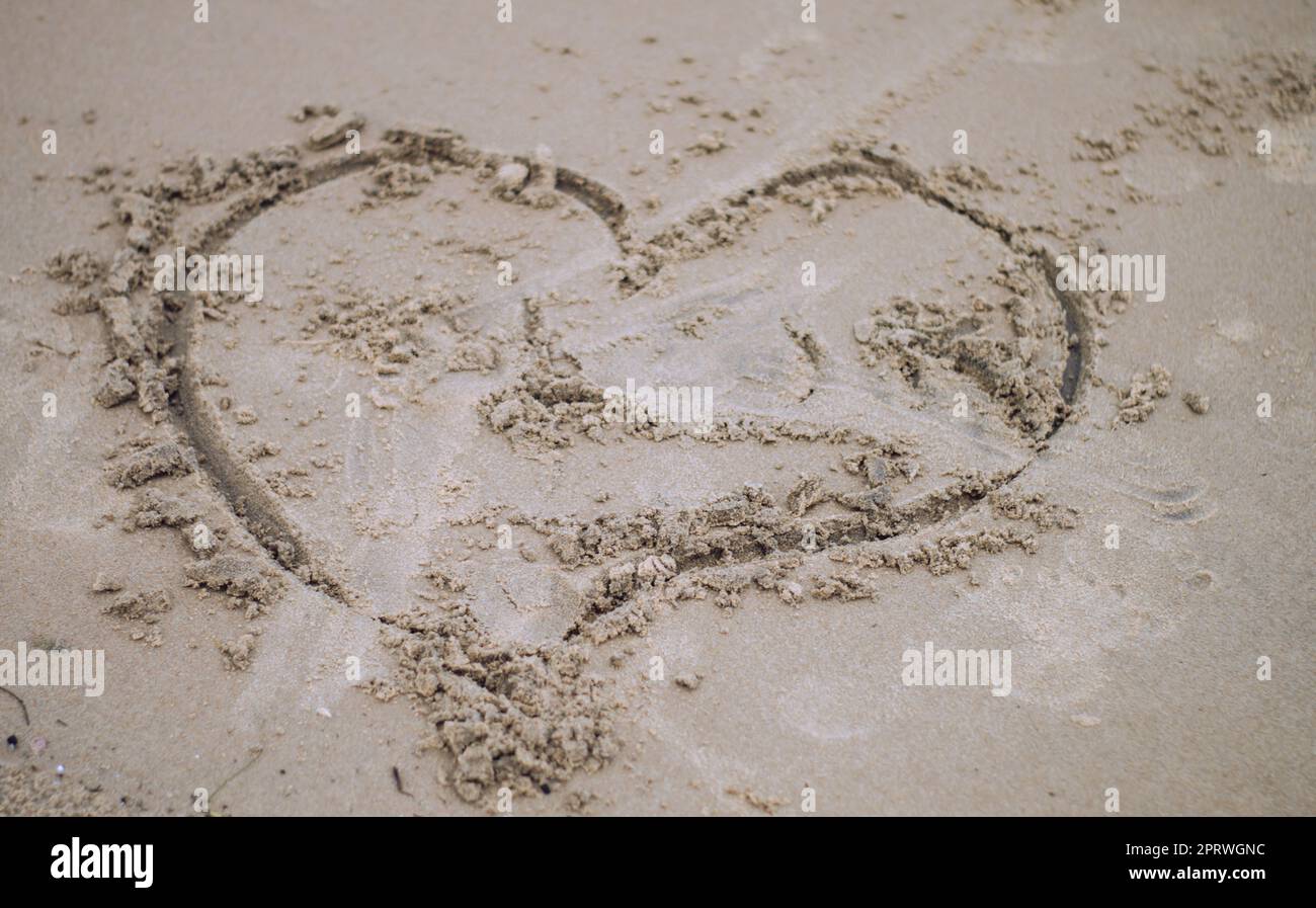 Liebe Zeichen auf Sand. Love Heart Symbol im Sand am tropischen Strand. Feiertage Hintergründe Texturen. Puri, Odisha, Indien Stockfoto