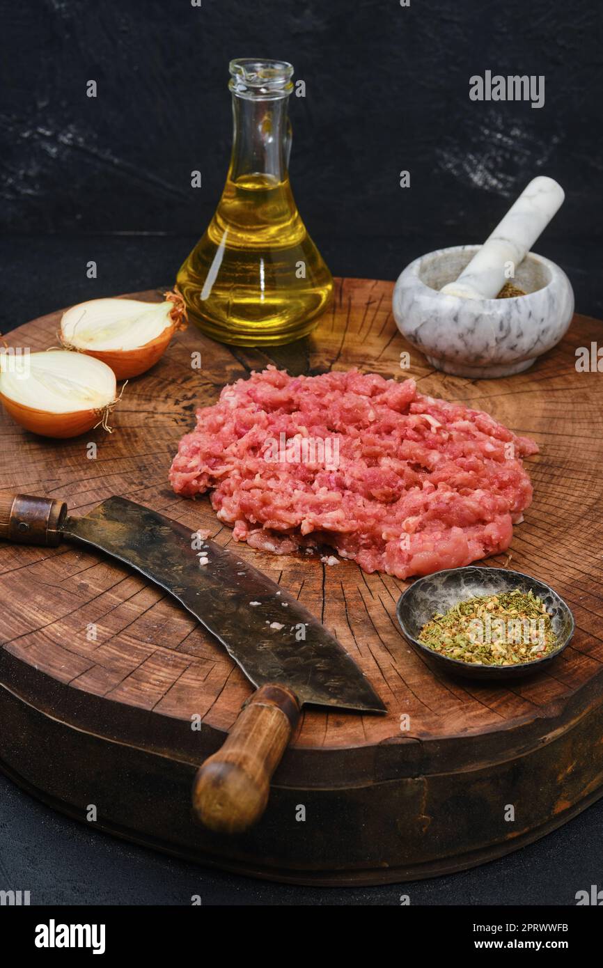 Rustikaler Stil bei der Zubereitung von frischem Hackfleisch mit einem Schneidmesser Stockfoto