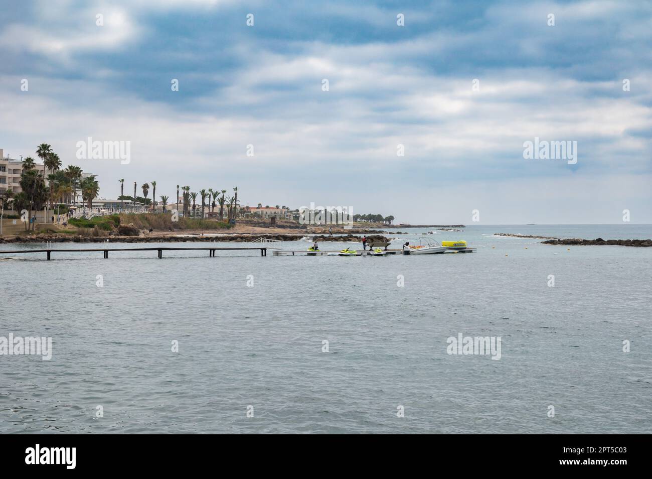 Paphos, Zypern - 27. März 2023 - die Küste mit Wassersportaktivitäten am Strand Stockfoto