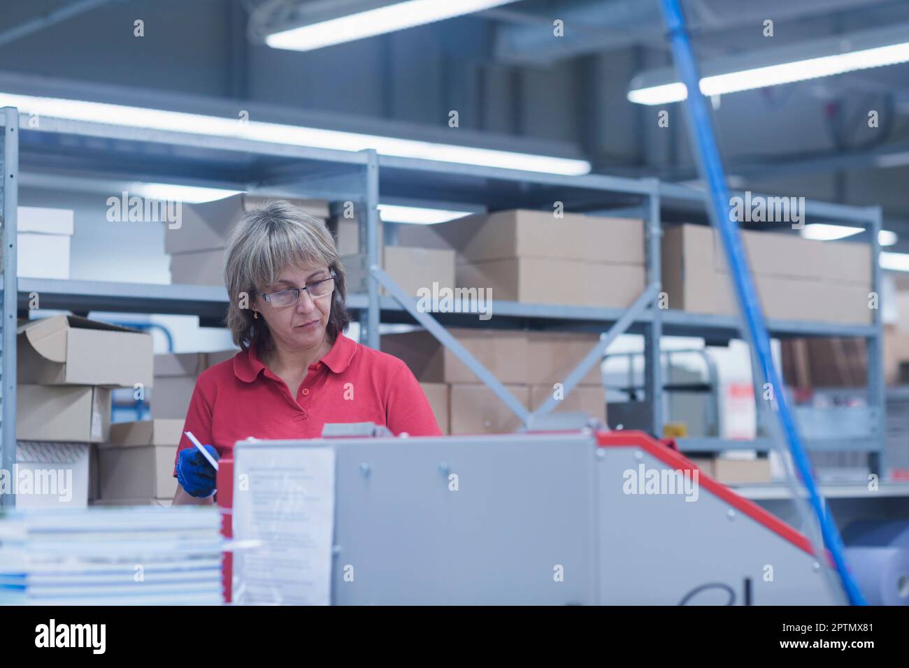 Reife Frau in der Buchdruckindustrie, Bremgarten, Hartheim am Rhein, Baden-Württemberg, Deutschland Stockfoto