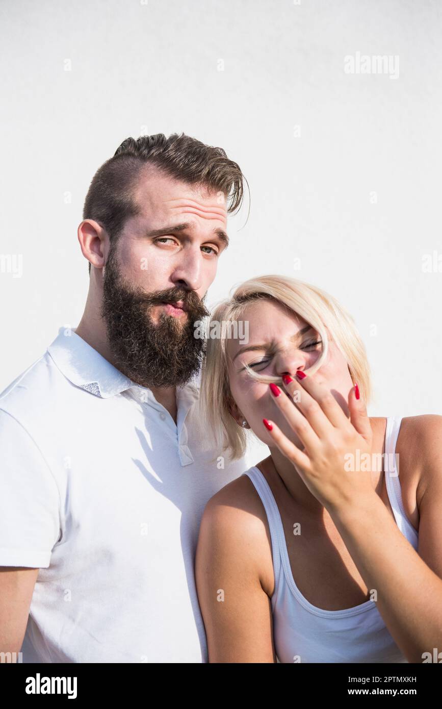 Junger Mann mit seiner verspielten Freundin, macht Schnurrbart mit Haaren, Bayern, Deutschland Stockfoto