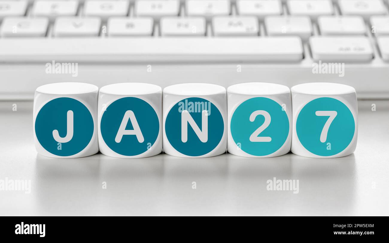 Buchstabenwürfel vor einer Tastatur - Januar 27 Stockfoto