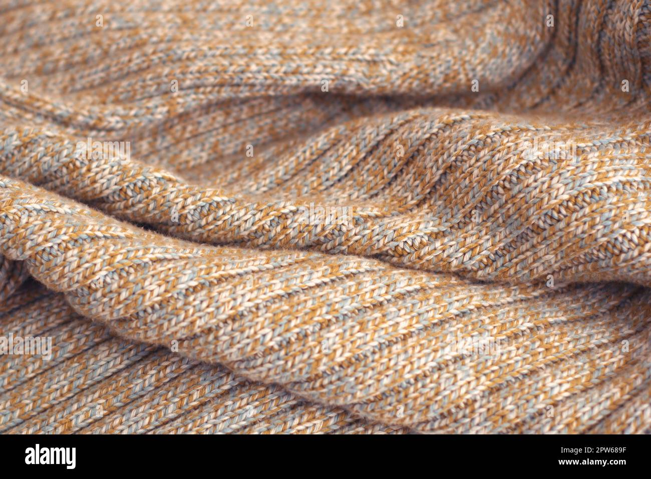 Meliert beige gestrickten Wollpullover. Textur Detail Nahaufnahme. Stockfoto