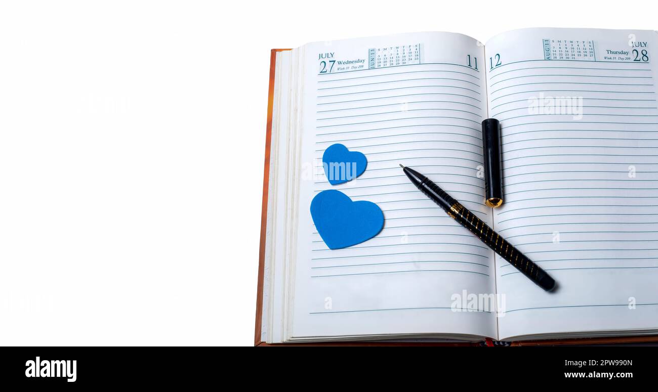 Liebeskonzept. Notizbuch mit Stift und blauen Herzen isoliert auf weißem Hintergrund. Stockfoto