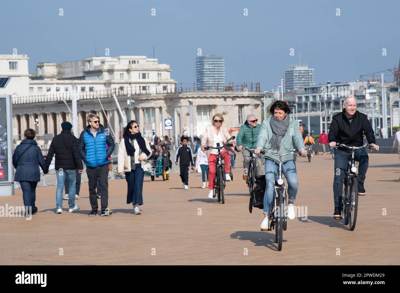 Menschen, die an der Strandpromenade in Ostende, Belgien, entlang der Nordsee Sport treiben und spazieren gehen. Stockfoto