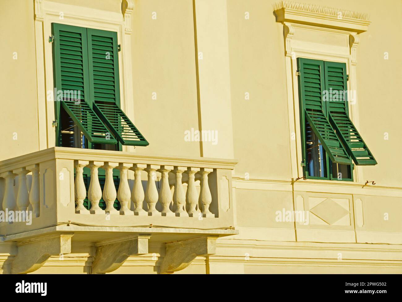 Ein Teil der Fassade eines Hauses mit Balkon und zwei Fenstern Stockfoto