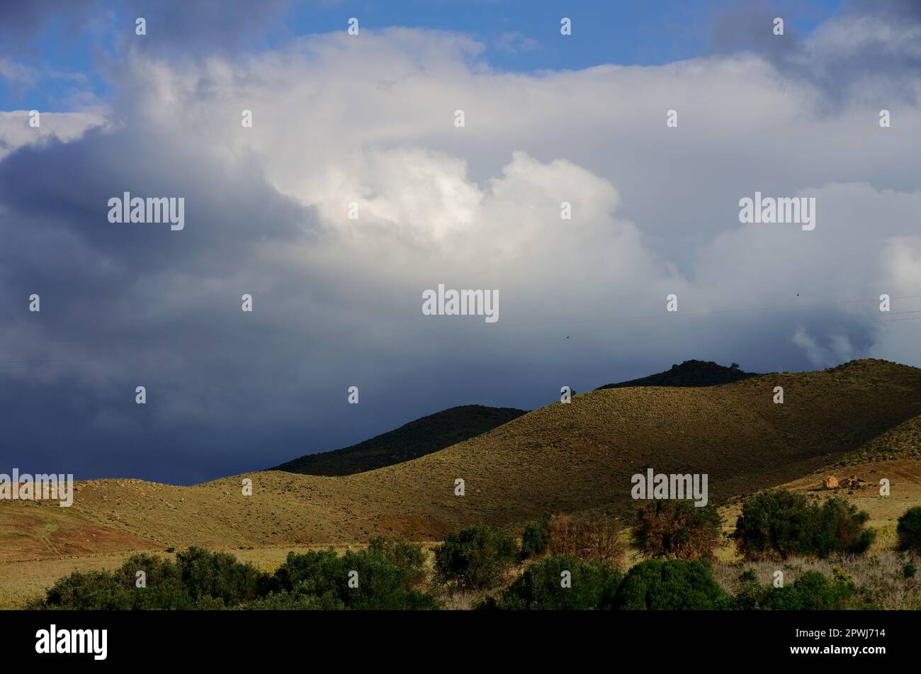 Dramatische Landschaft mit blauen Sturmwolken auf dem ländlichen Sizilien an einem sonnigen und regnerischen Tag im Frühling, Italien Stockfoto