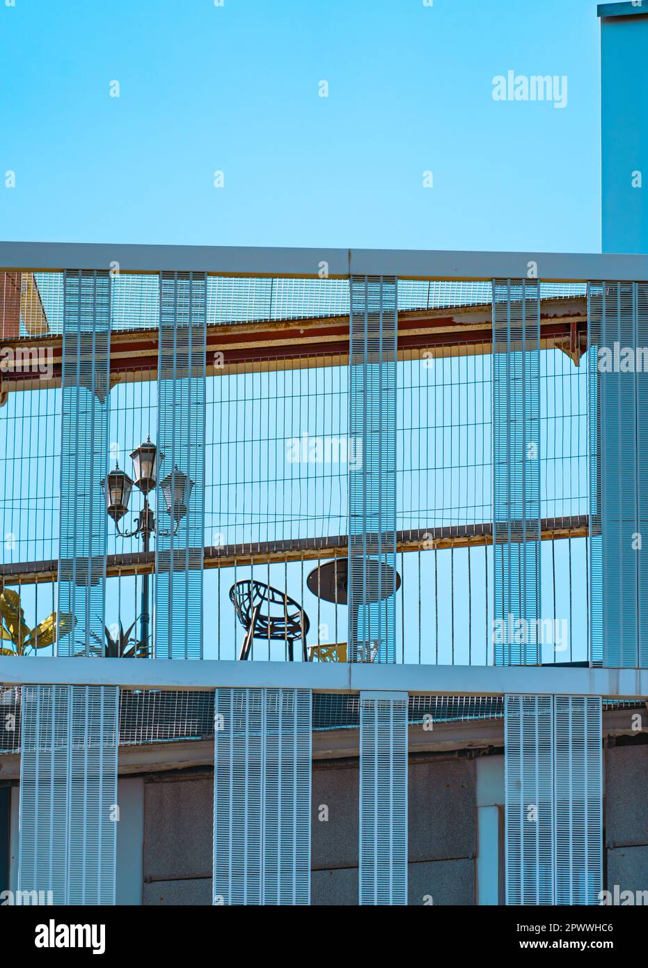 Details der Fassade und Struktur eines modernen, avantgardistischen und minimalistischen Gebäudes mit großen rechteckigen blauen Kristallen und einer Terrasse im Stockfoto