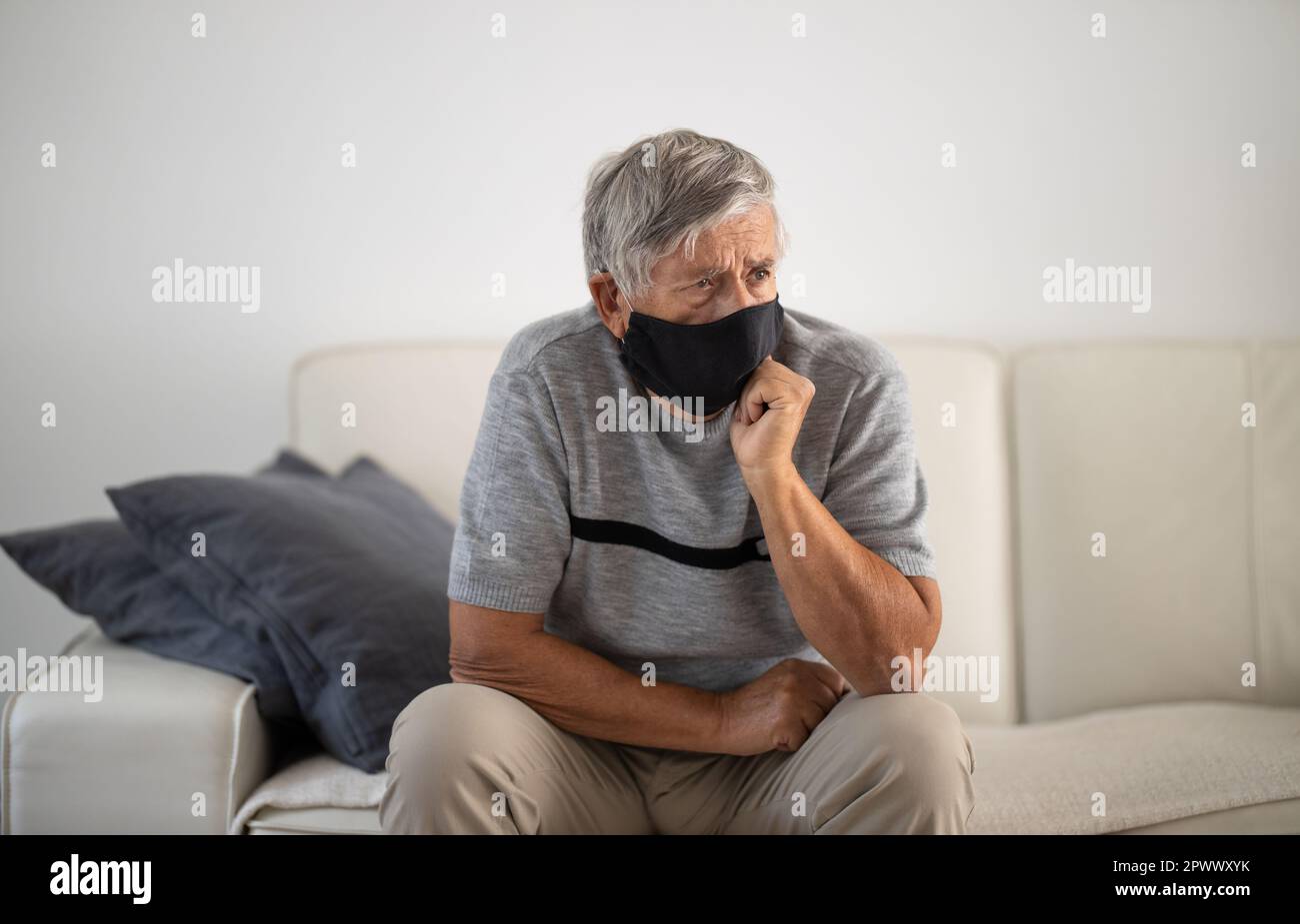 Älterer Mann mit Gesichtsbedeckung während des Coronavirus- und Grippeausbruchs. Schutz vor Viren und Krankheiten, Quarantäne zu Hause. COVID-19 Konzept Stockfoto