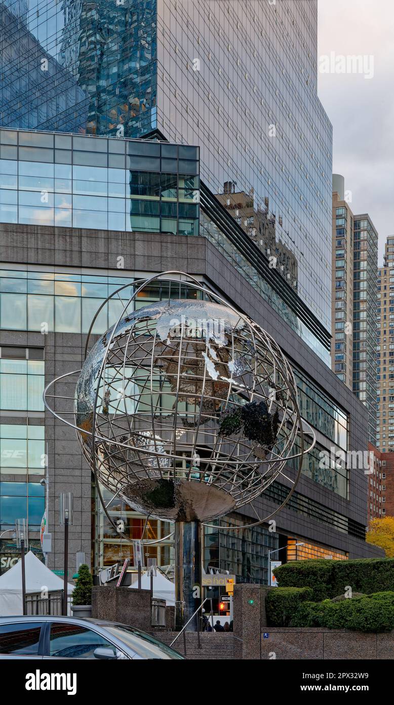 Kim Brandells Globe Sculpture vor der Kulisse der Geschäfte am Columbus Circle, wo sich Broadway und Central Park West kreuzen. Stockfoto