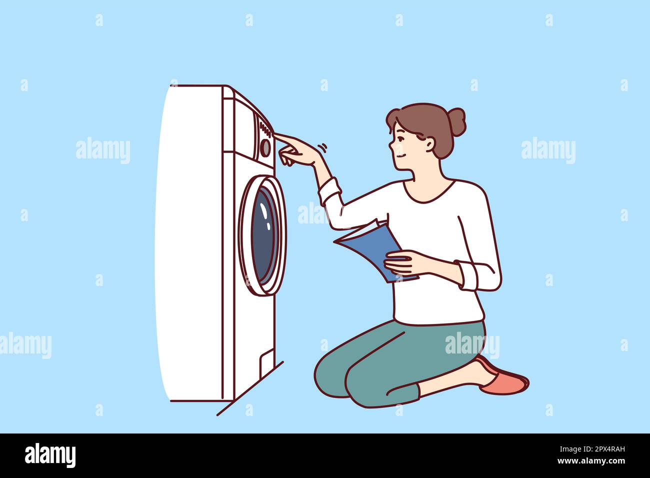 Die Frau schaltet die Waschmaschine auf Knien ein und gibt Anweisungen auf  Papier mit Regeln für die Benutzung der Geräte. Eine lässige junge Hausfrau  mit Lächeln baut nach dem manuellen Lernen eine