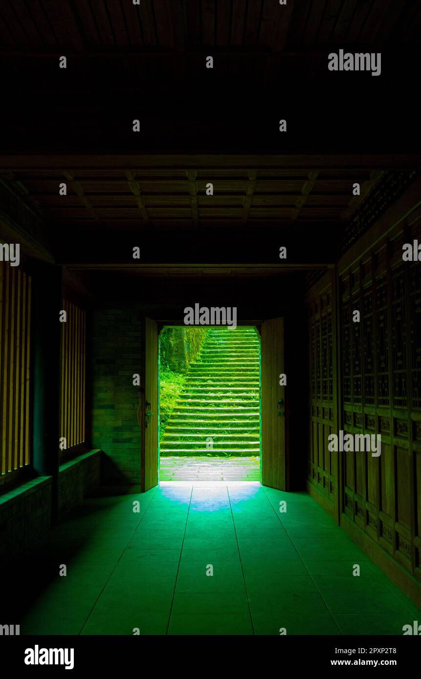 Dieses Bild zeigt einen Raum mit zwei offenen Türen auf beiden Seiten einer Treppe Stockfoto