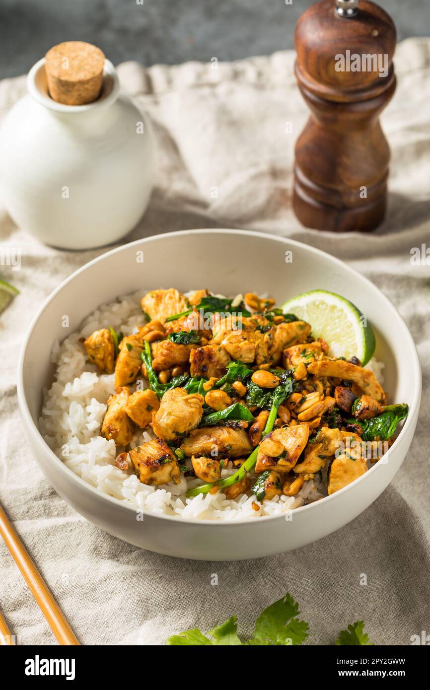 Asiatisches Ingwer-Erdnuss-Hühnchen und Reis mit Limone und Kräutern Stockfoto